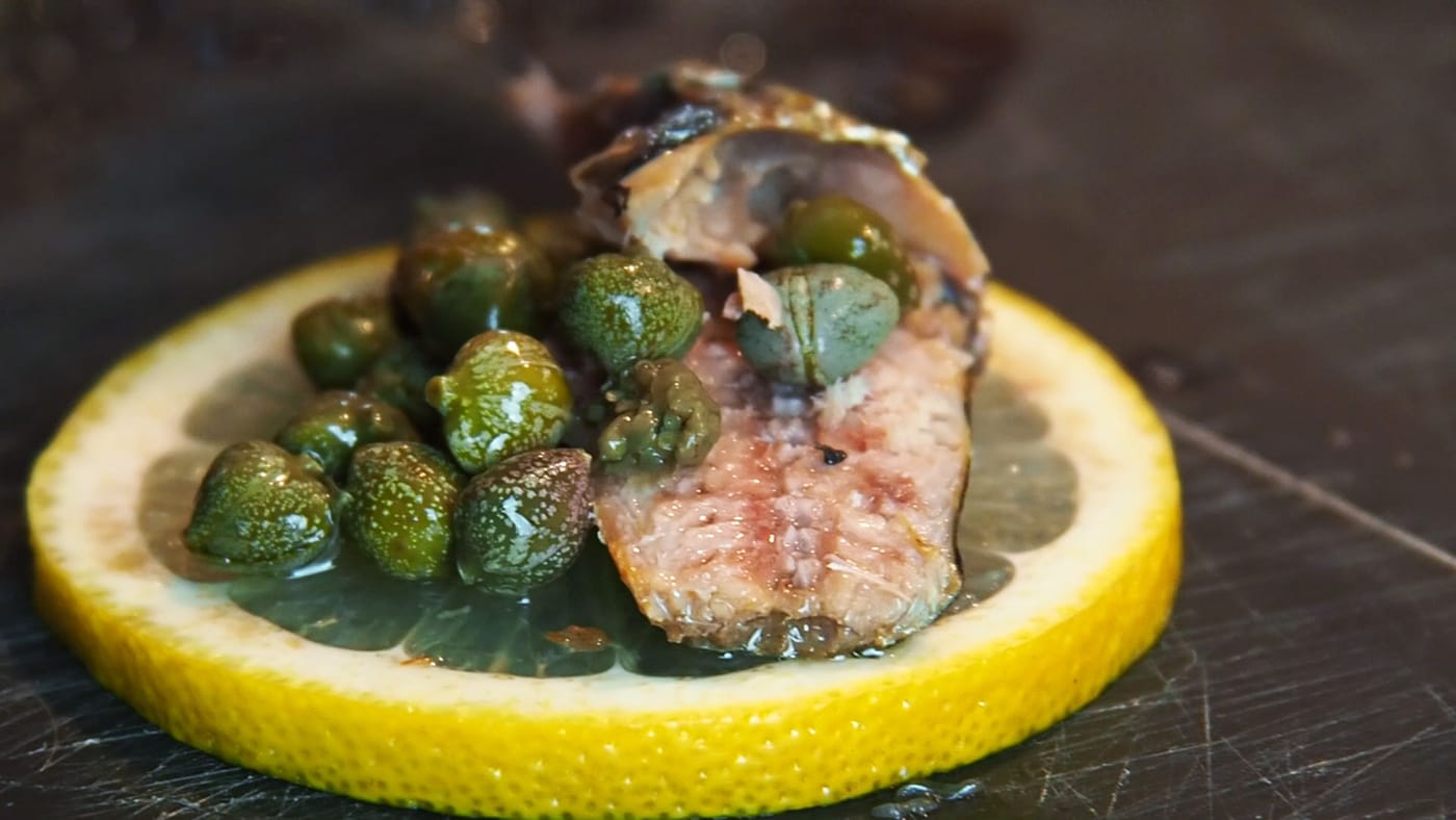 slice of lemon, capers, fish