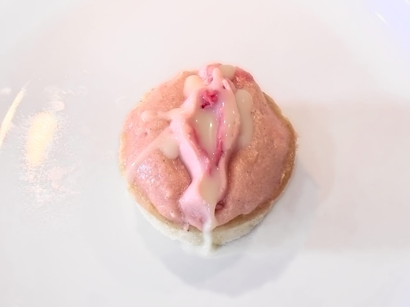 A vulva cupcake drizzled with sweetened condensed milk