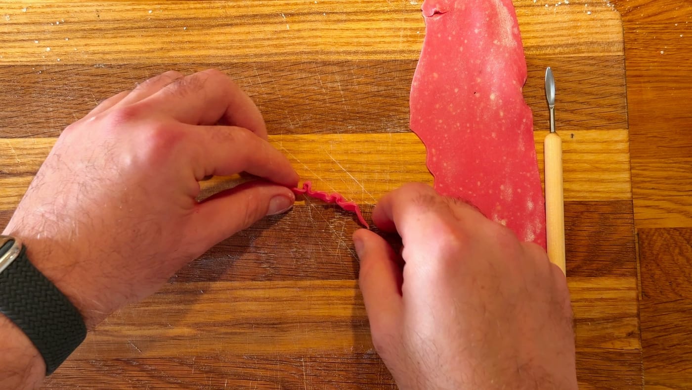 Rolling the dark chocolate clay into thin, ruffled strips